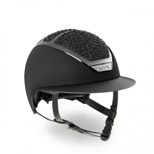 The Dogma Star Lady On The Rockss is an innovative equestrian helmet with pleasing aesthetics designed specifically for women riders.   Each one is individually handcrafted in Italy. The sparkling details can be applied on all the helmets of KASK equestrian collection.  KASK’s patented self-adapting adjustment system, introduced for the first time in the equestrian market, allows the helmet to fit the rider’s head perfectly and automatically by gently cradling the back of the head. It is highly popular amon